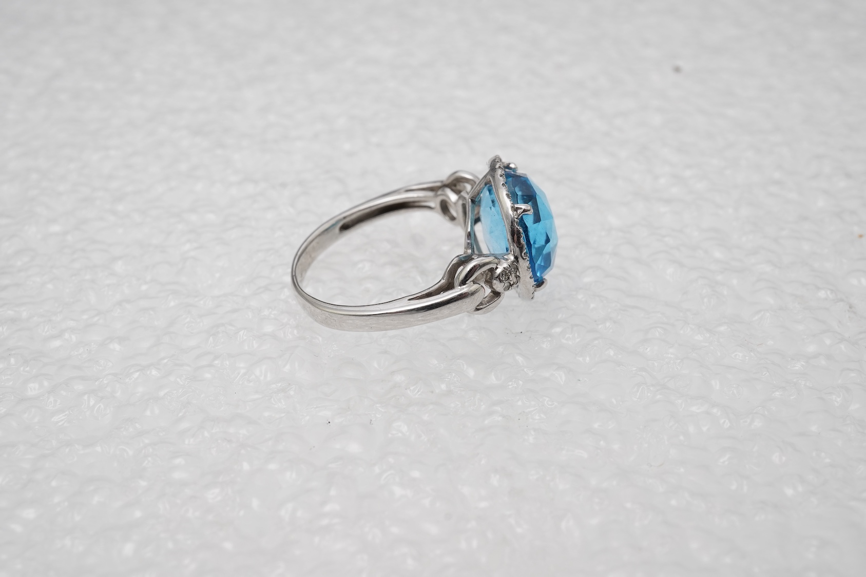A blue topaz and diamond ring